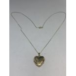 A 9 CARAT GOLD NECKLACE WITH HEART SHAPED LOCKET IN A PRESENTATION BOX