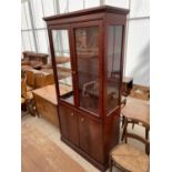 A STAG TWO DOOR GLAZED BOOKCASE ON BASE, 36" WIDE