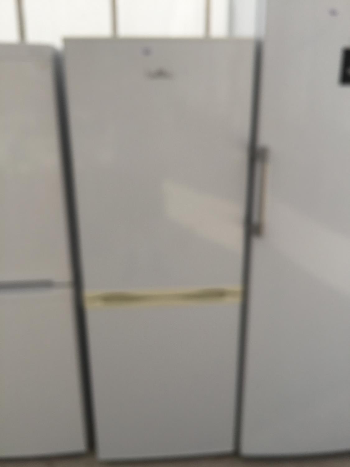 A WHITE NEWWORLD UPRIGHT FRIDGE FREEZER BELIEVED IN WORKING ORDER BUT NO WARRANTY