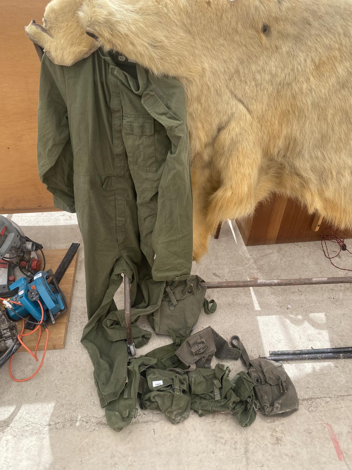 A GREEN OVERALL AND AN ASSORTMENT OF BAGS