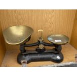 A PAIR OF BRASS KITCHEN SCALES