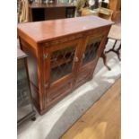 A STANLEY WOOD OAK GLAZED AND LEADED BOOKCASE WITH CUPBOARDS TO THE BASE, 42" WIDE