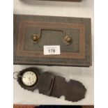A VINTAGE CASH TIN AND A WHITE METAL POCKET WATCH IN CARVED TREEN CASE
