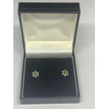 A PAIR OF 18 CARAT GOLD, EMERALD AND POSSIBLY DIAMOND EARRINGS IN A FLOWER DESIGN WITH A
