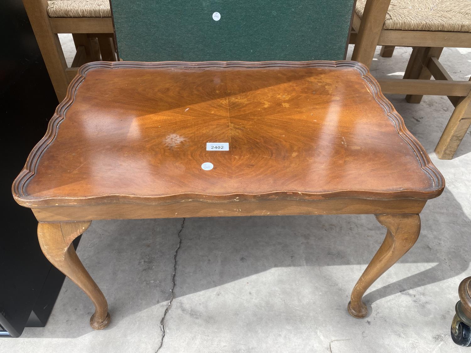 A WALNUT COFFEE TABLE ON CABRIOLE LEGS TOGETHER WITH A CARD TABLE