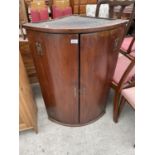 A GEORGE III MAHOGANY TWO DOOR BOWFRONTED CORNER CUPBOARD