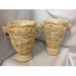 A PAIR OF HEAVILY CARVED ORIENTAL VASES WITH ELEPHANT DESIGN TWIN HANDLES 30CM HIGH