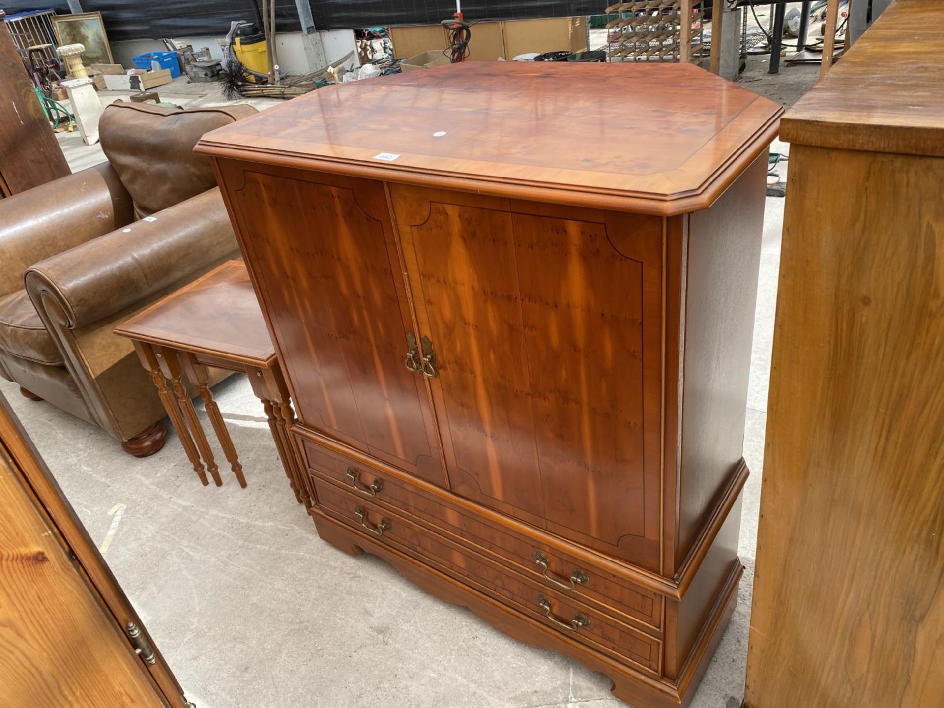 A YEW WOOD TV CABINET AND A NEST OF TABLES