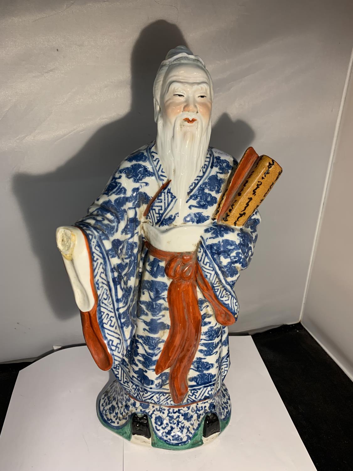 A FIGURINE OF A CHINESE MAN A/F