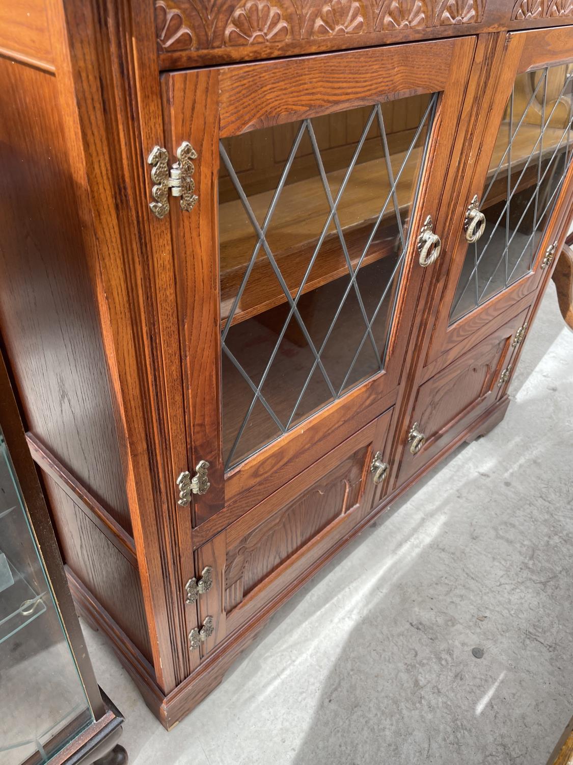 A STANLEY WOOD OAK GLAZED AND LEADED BOOKCASE WITH CUPBOARDS TO THE BASE, 42" WIDE - Image 3 of 4