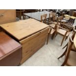 A MODERN PINE DROP-LEAF TABLE AND THREE CARVER CHAIRS