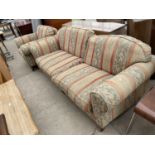 A DELCOR VICTORIAN STYLE SETTEE AND EASY CHAIR, ON TURNED LEGS