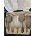 THREE HALLMARKED SHEFFILED SILVER BACKED BRUSHES IN A PRESENTATION BOX