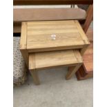 A NEST OF TWO OAK TABLES