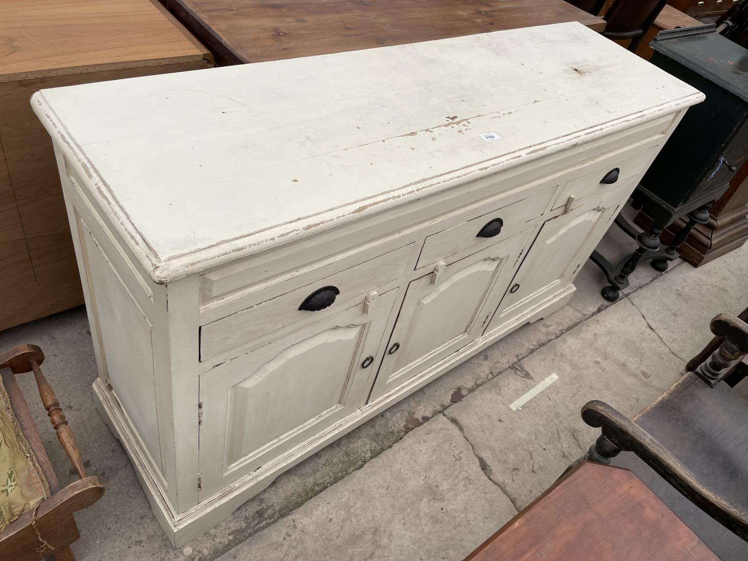 A PAINTED HARDWOOD VICTORIAN STYLE SIDEBOARD, 57" WIDE, ENCLOSING THREE PANELLED DOORS AND THREE