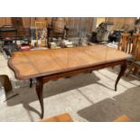 A MAHOGANY EXTENDING DINING TABLE ON CARVED CABRIOLE SUPPORTS