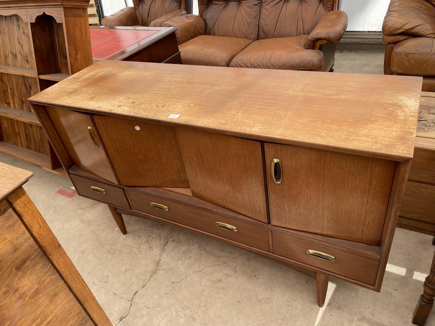 A RETRO TEAK G-PLAN SIDEBOARD ENCLOSING BI-FOLD DOORS AND THREE DRAWERS TO THE BASE, 57" WIDE