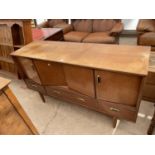 A RETRO TEAK G-PLAN SIDEBOARD ENCLOSING BI-FOLD DOORS AND THREE DRAWERS TO THE BASE, 57" WIDE