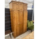 A MODERN PINE THREE DOOR WARDROBE