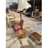 AN OVAL WALNUT MODERN OCCASIONAL TABLE ON TRIPOD BASE AND 1970'S STANDARD LAMP COMPLETE WITH SHADE