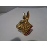 A SILVER GILT PENDANT IN THE FORM OF A HARE WITH A PINK STONE COLLAR