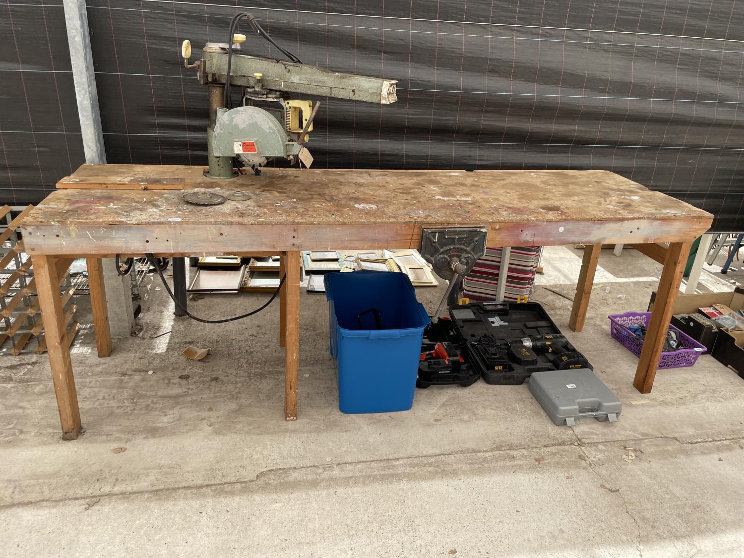 A LARGE INDUSTRIAL WORK BENCH WITH RECORD BENCH VICE AND DEWALT CIRCULAR SAW