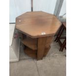 A MID 20TH CENTURY OCTAGONAL THREE TIER OCCASIONAL TABLE