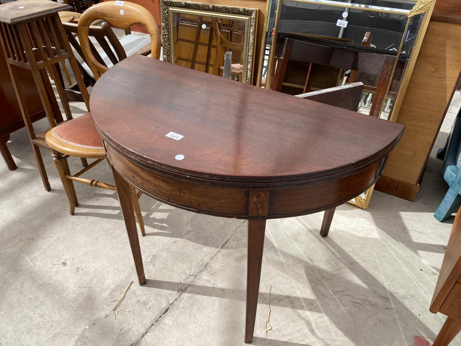 A GEORGE III MAHOGANY AND INLAID FOLD-OVER TEA TABLE, 35" DIAMETER OPENED