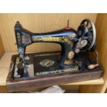 A VINTAGE SINGER SEWING MACHINE WITH WOODEN CARRY CASE