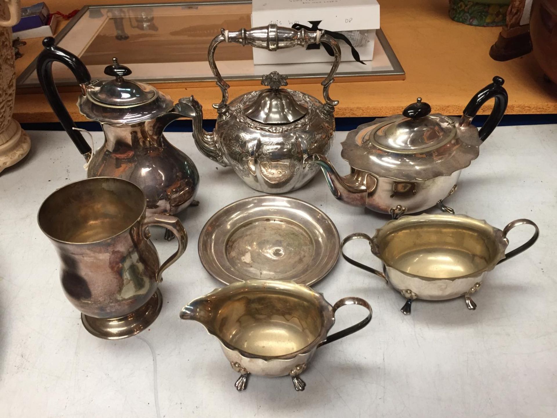 A SELECTION OF SILVER PLATED ITEMS TO INCLUDE TEA POTS, SUGAR BOWL AND TWO FURTHER ITEMS