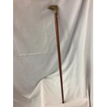 A WALKING STICK WITH A BRASS EAGLE HEAD