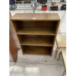 AN OPEN OAK BOOKCASE, 24" WIDE