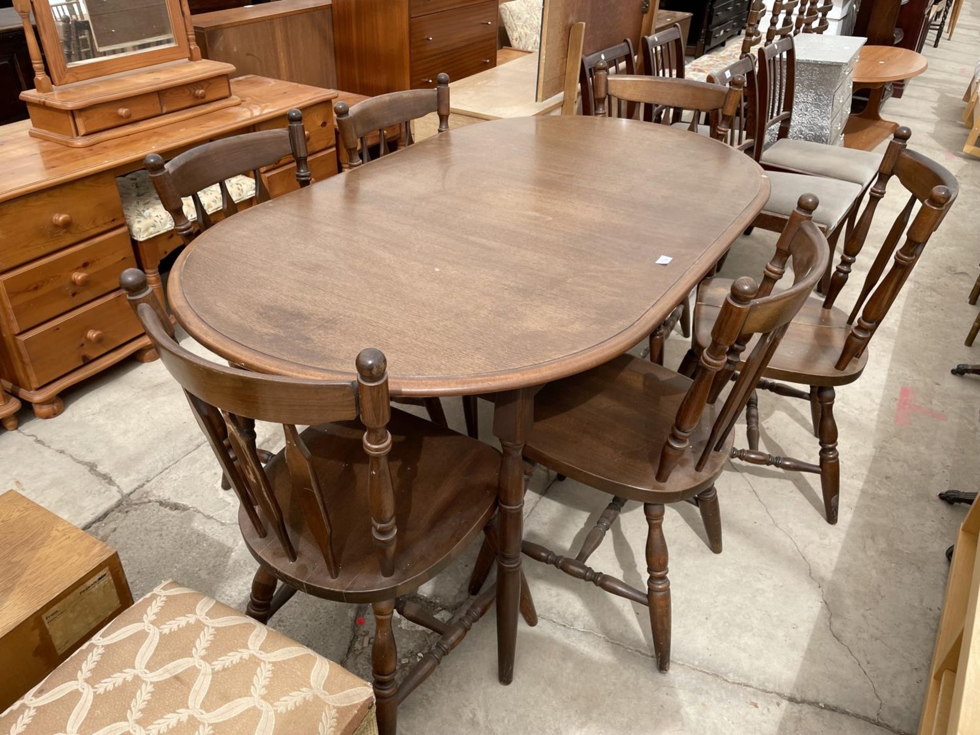 A MODERN EXTENDING DINING TABLE AND SIX MATCHING CHAIRS