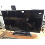 A LOGIK 32" TELEVISION WITH REMOTE CONTROL