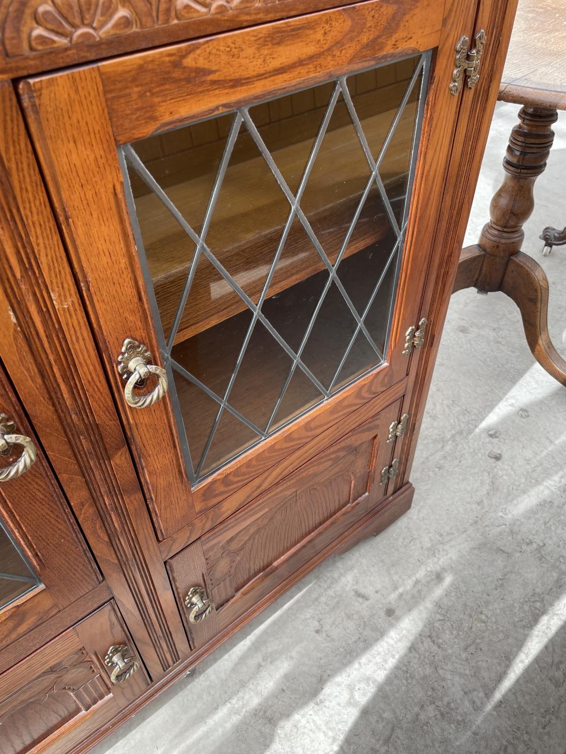 A STANLEY WOOD OAK GLAZED AND LEADED BOOKCASE WITH CUPBOARDS TO THE BASE, 42" WIDE - Image 4 of 4