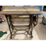 A RUSTIC TABLE WITH A VINTAGE MANGLE BASE