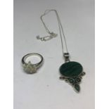 A SILVER NECKLACE WITH A GREEN STONE PENDANT AND A RING IN A FLOWER DESIGN WITH A PRESENTATION BOX