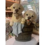 A RESIN GARDEN ORNAMENT OF TWO GOLDEN LABRADOR PUPPIES