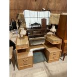AN OAK ART DECO STYLE DRESSING TABLE WITH UNFRAMED MIRROR, SIX DRAWERS AND TWIN LAMPS