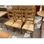 A SET OF SIX PINE LADDER-BACK DINING CHAIRS