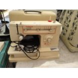 A RETRO SINGER SEWING MACHINE WITH CARRY CASE