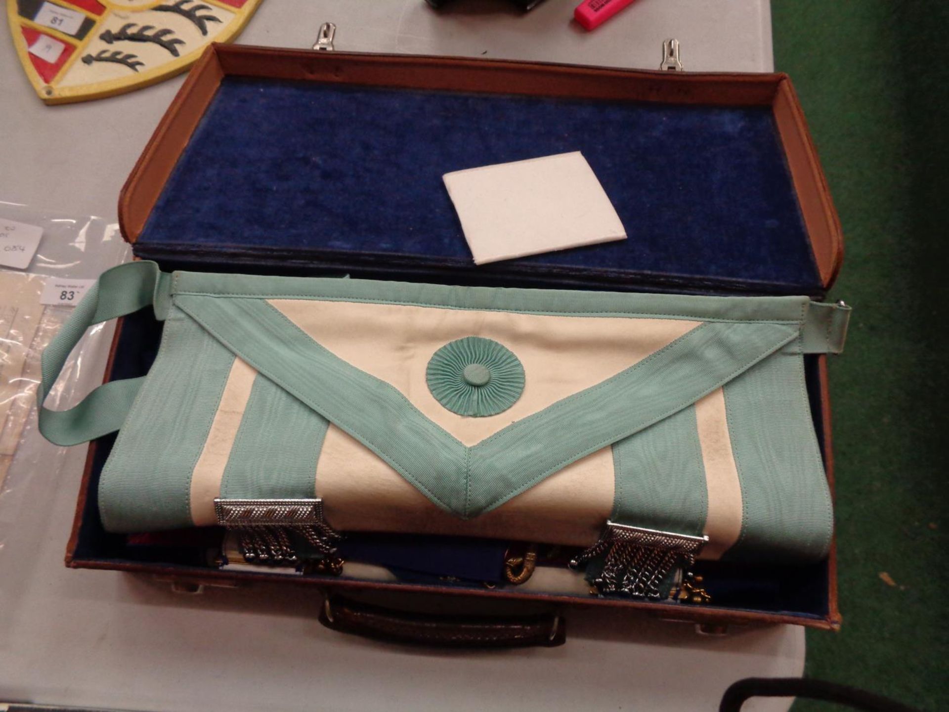 A LEATHER CASE CONTAINING MASONIC REGALIA