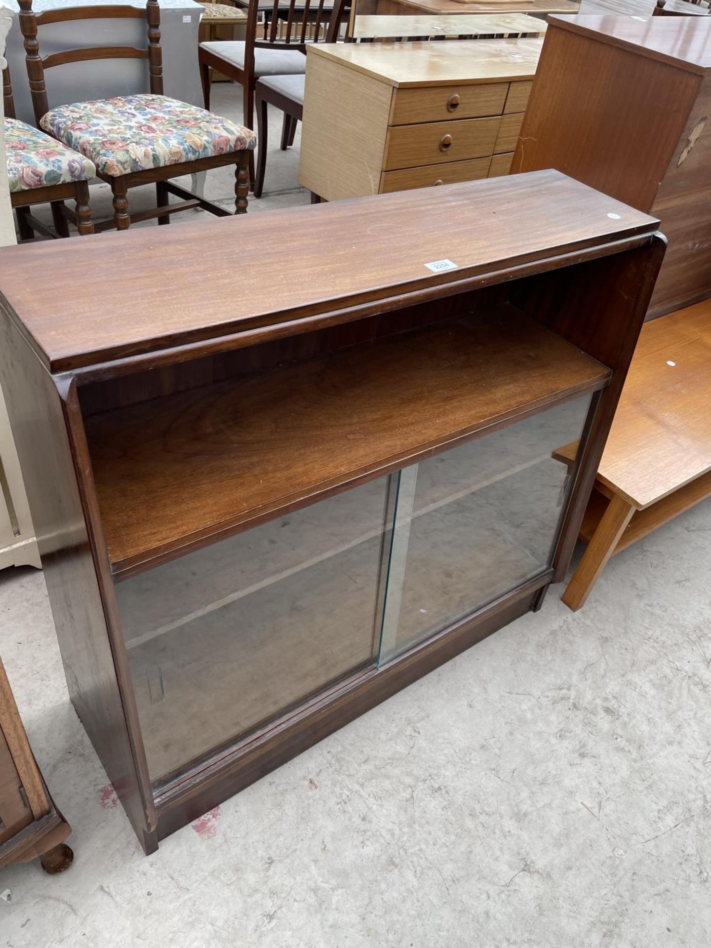 A MID 20TH CENTURY MAHOGANY SLIDING GLASS FRONTED BOOKCASE, 36" WIDE