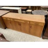 A RETRO TEAK SIDEBOARD ENCLOSING FOUR CUPBOARDS, THREE DRAWERS, 67" WIDE