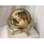 A GEM STONE AND PEARLISED GLOBE ON BRASS STAND 32CM HIGH