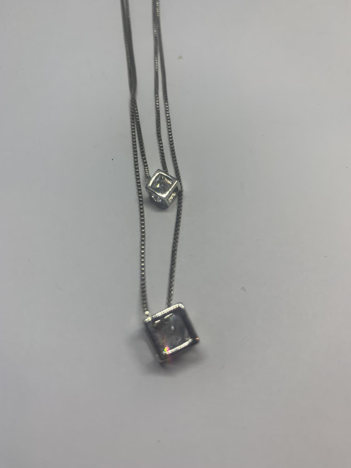 A DOUBLE STRAND SILVER NECKLACE WITH CLEAR STONE CUBE PENDANTS AND A SILVER RING WITH CLEAR STONE IN - Image 2 of 3