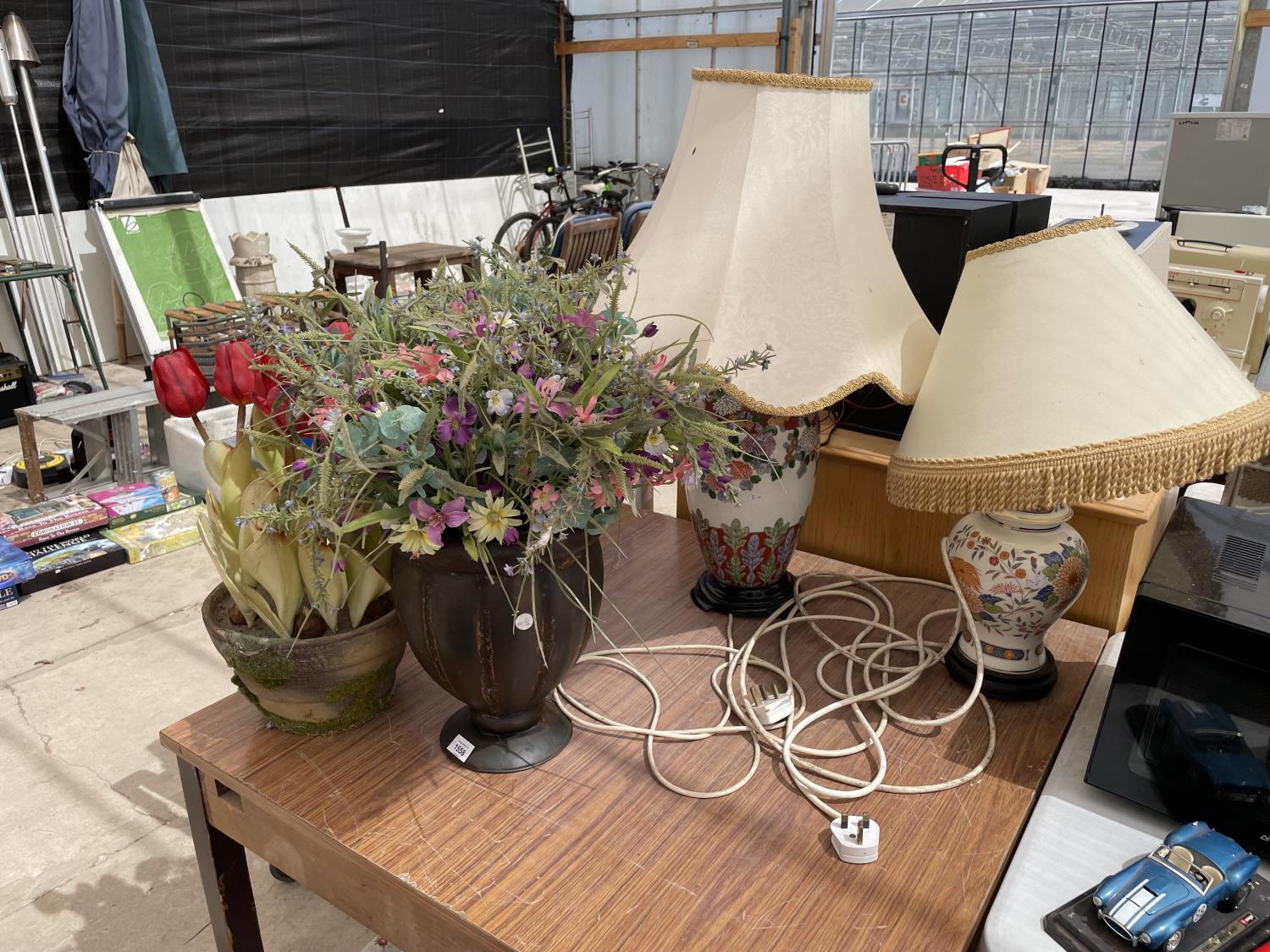 A VASE AND A PLANT POT CONTAINING ARTIFICIAL FLOWERS