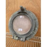 A VINTAGE BRASS FRAMED PORT HOLE