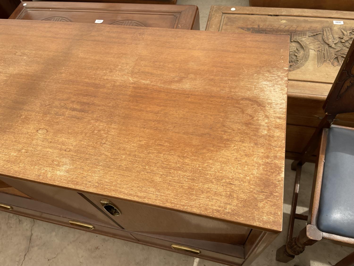 A RETRO TEAK G-PLAN SIDEBOARD ENCLOSING BI-FOLD DOORS AND THREE DRAWERS TO THE BASE, 57" WIDE - Image 2 of 7