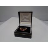 A 9 CARAT GOLD RING WITH THREE IN LINE RUBYS AND FOUR DIAMONDS SIZE P WITH A PRESENTATION BOX